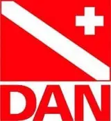 Red DAN logo showing a white diagonal diver-down stripe, a white medical cross in the top-right, and "DAN" in bold letters below.
